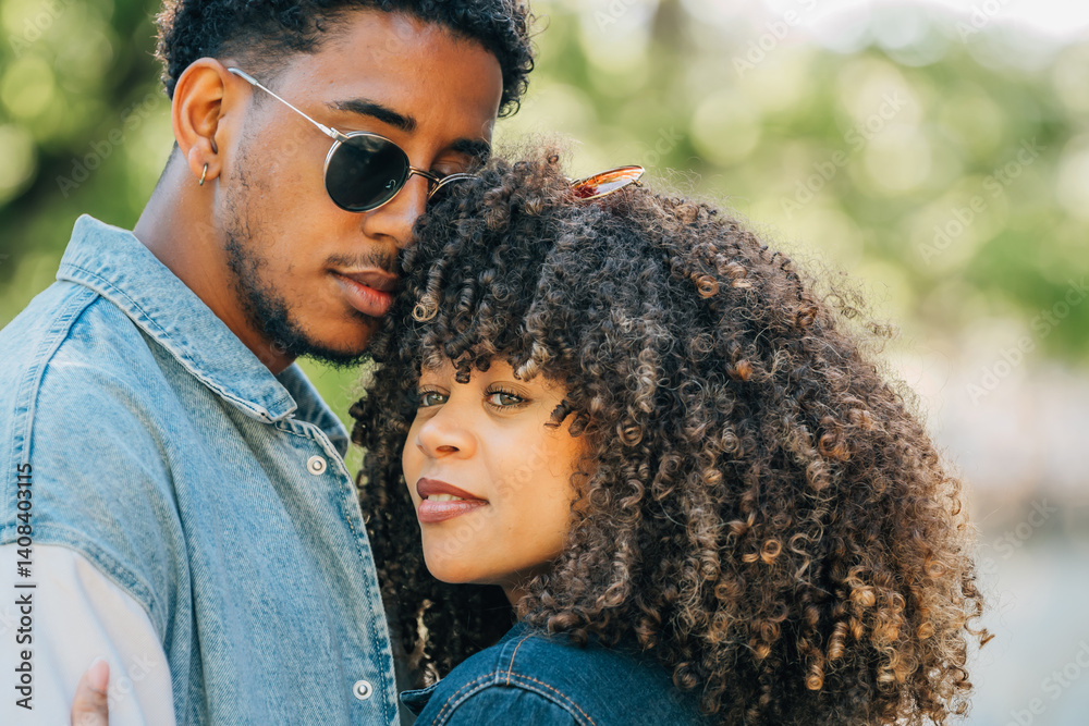 romantic latin couple hugging happily outdoors