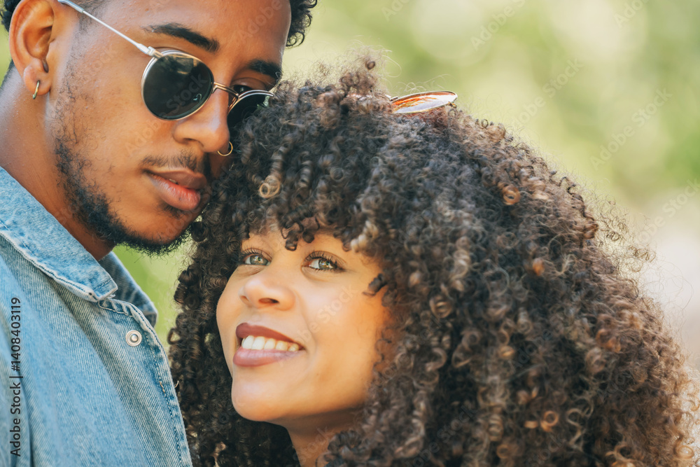romantic latin couple hugging happily outdoors