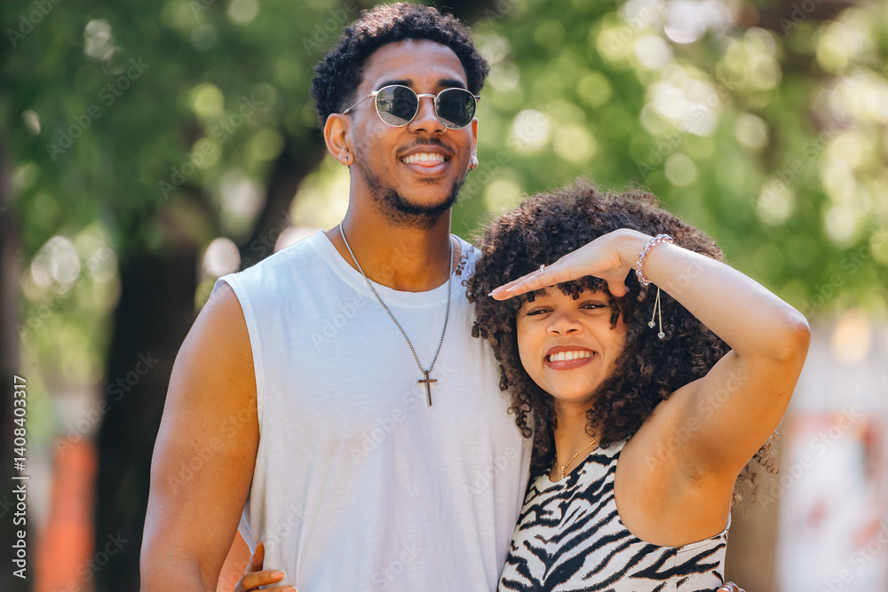young latin couple outdoors looking