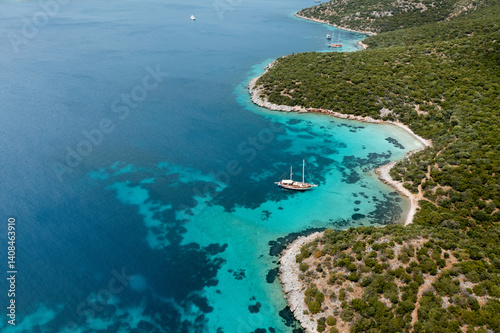 Gulet cruising along beautiful turquoise mediterranean coast in Bozburun Peninsula, Turkey
