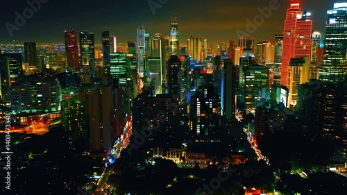 Aerial view of a vibrant city skyline at night, skyscrapers glowing with neon lights