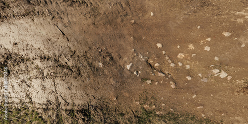 Obraz na płótnie view from above on surface of texture of dry road with tractor tire tracks in countryside w salonie