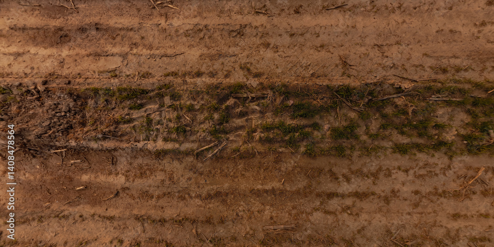 view from above on surface of texture of dry road with tractor tire tracks in countryside view from above on surface of texture of dry road with tractor tire tracks in countryside
