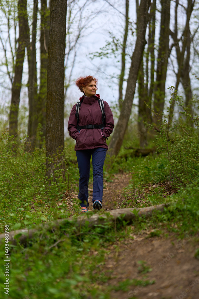 Woman hiking on forest trail