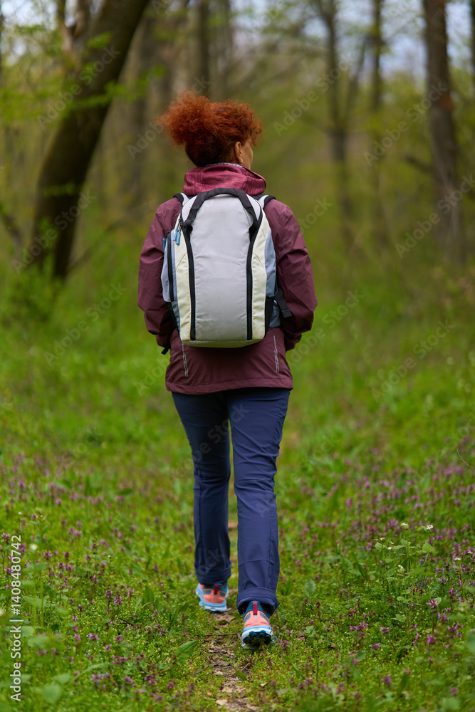Woman hiking alone in forest