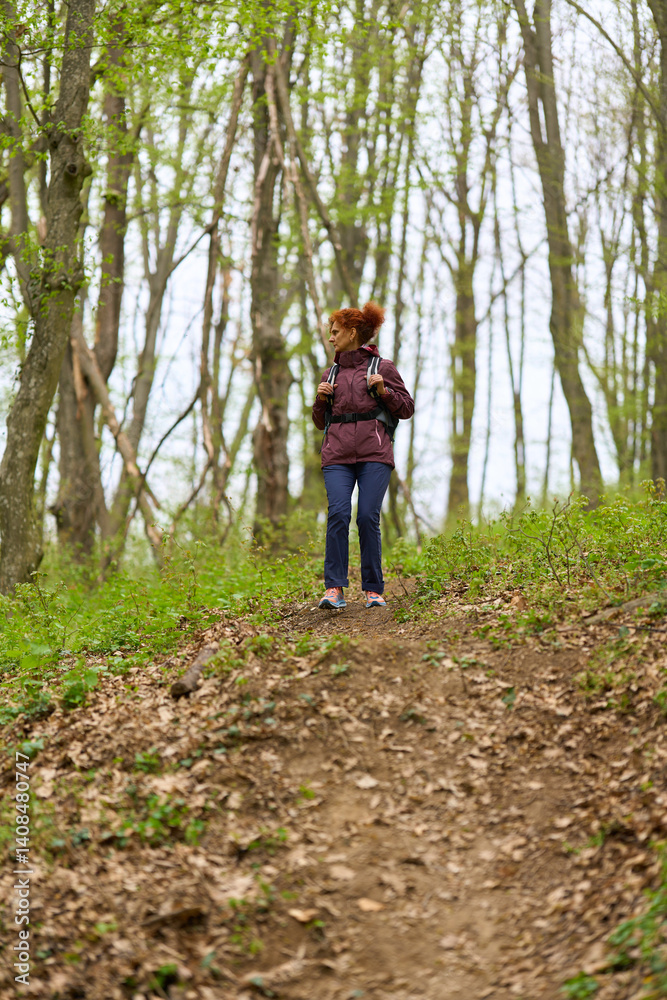 Woman hiking on forest trail