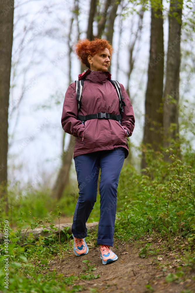 Woman hiking on forest trail
