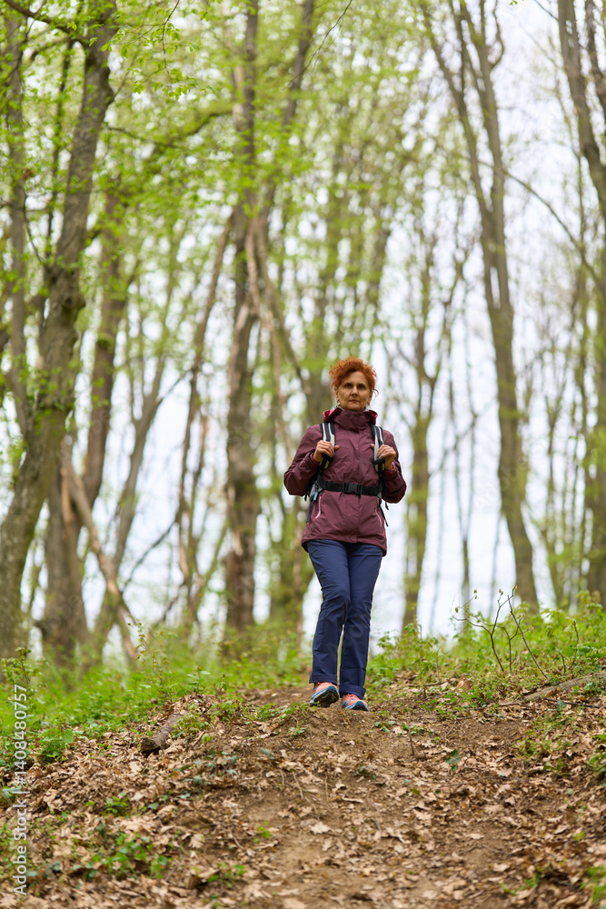 Woman hiking on forest trail