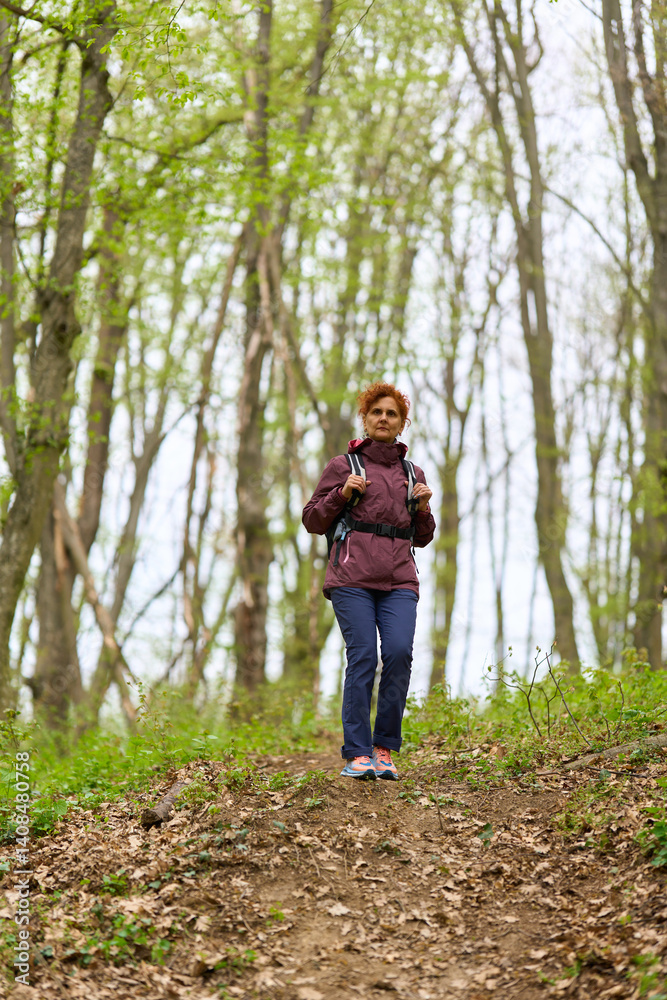 Woman hiking on forest trail