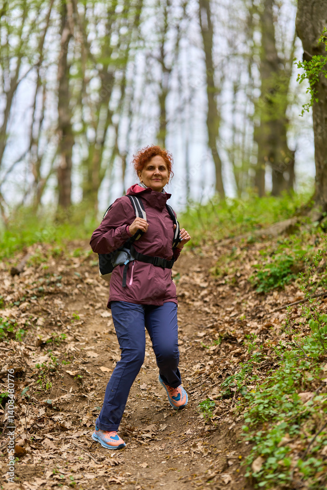 Woman hiking on forest trail