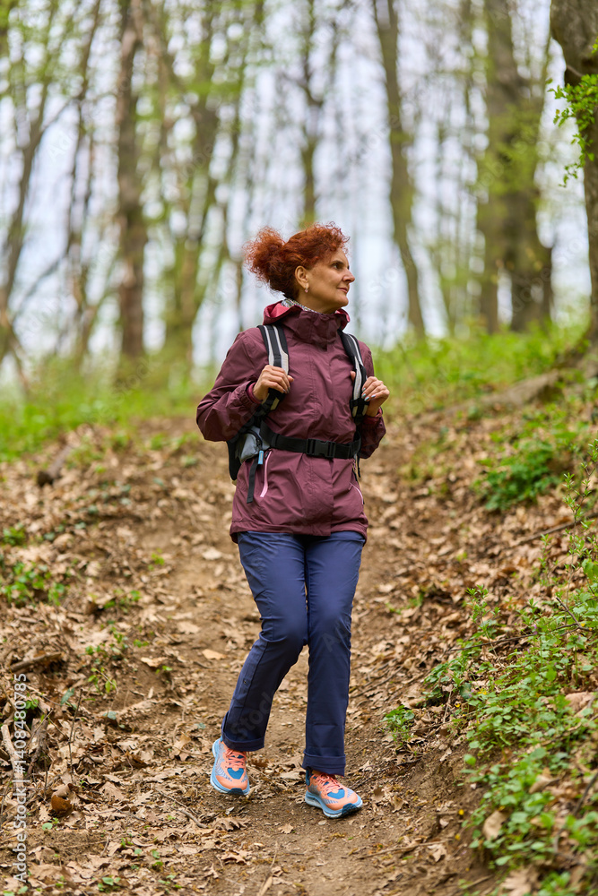 Woman hiking on forest trail