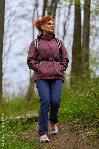 Woman hiking on forest trail