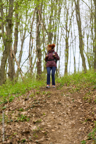Obraz na płótnie Woman hiking on forest trail w salonie