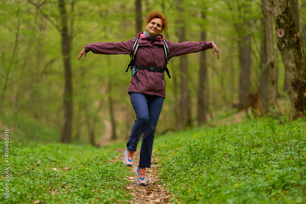 Woman jumping joyfully in forest