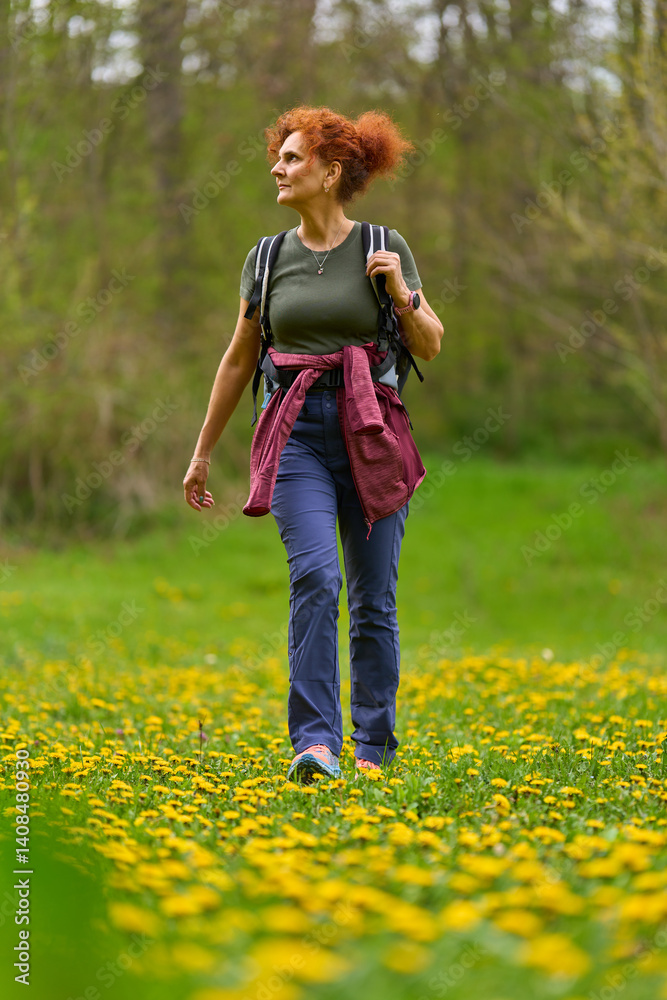 Woman hiking in dandelion meadow