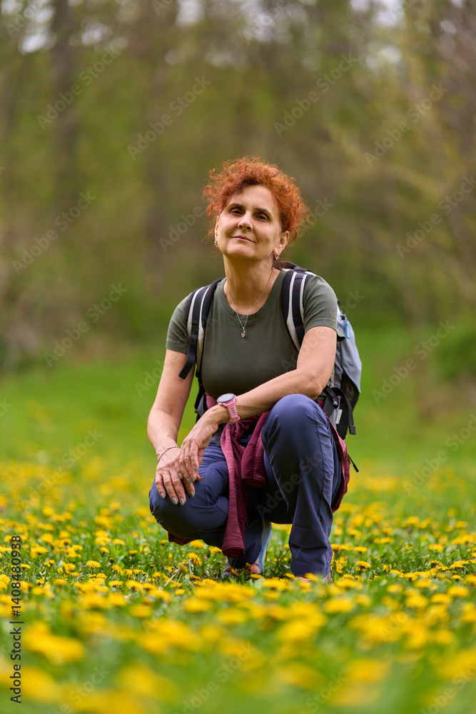 Woman resting in dandelion field