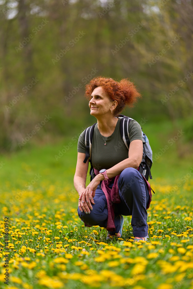 Woman resting in dandelion field
