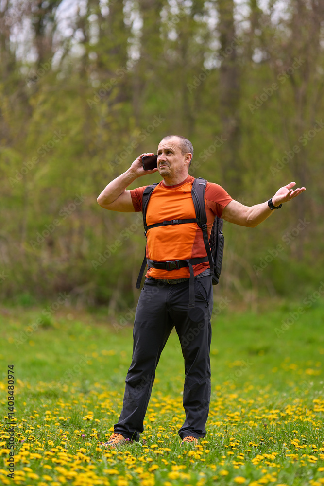 Frustrated man on phone while hiking