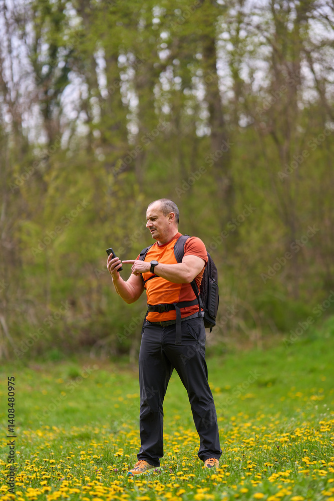 Man using phone on hiking trail