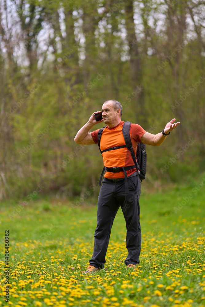 Frustrated man on phone while hiking