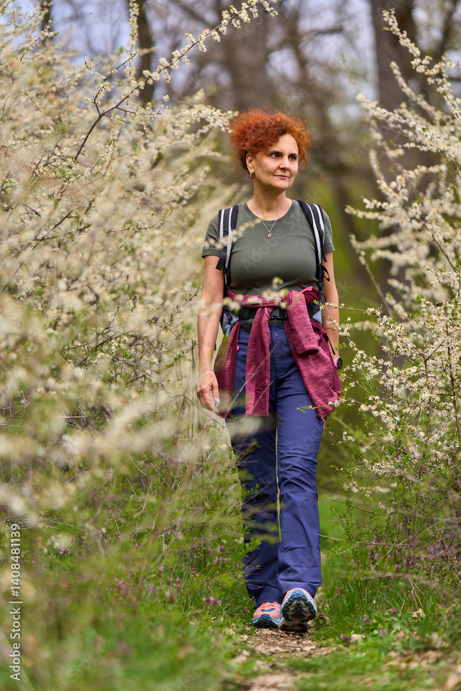 Woman walking through blooming blackthorn