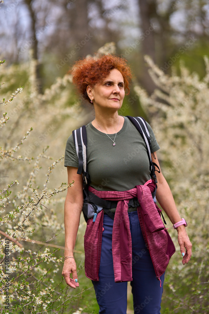 Woman walking through blooming blackthorn