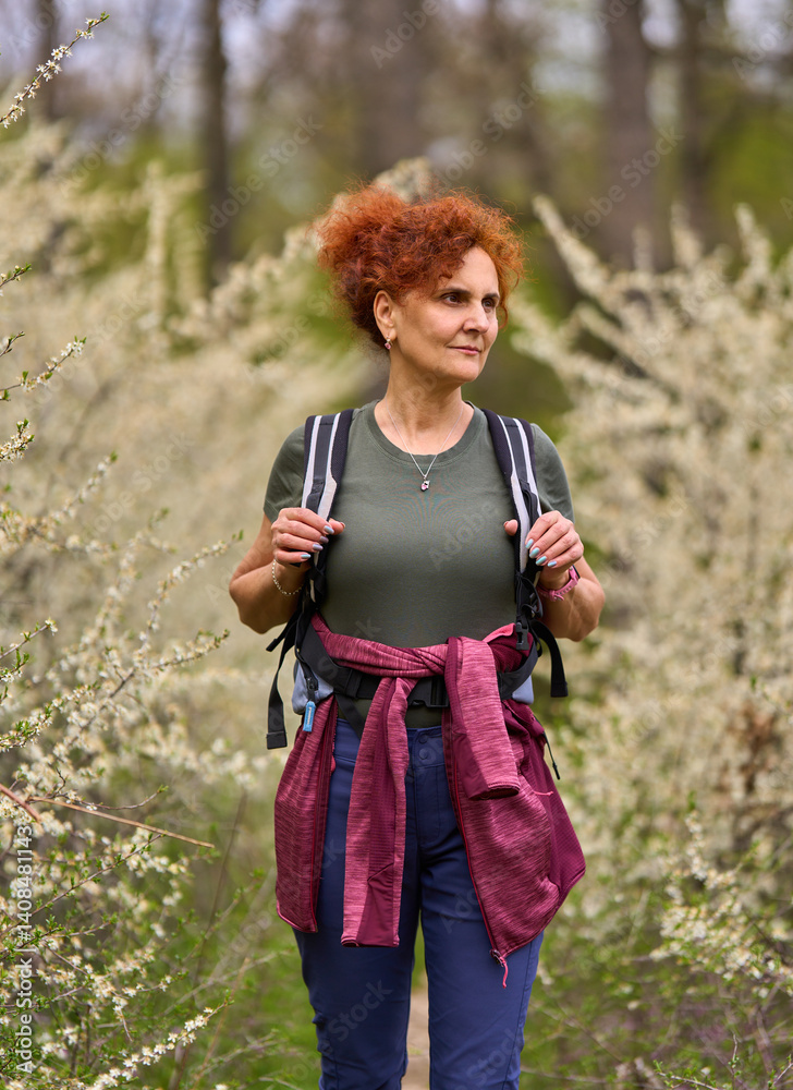 Woman walking through blooming blackthorn