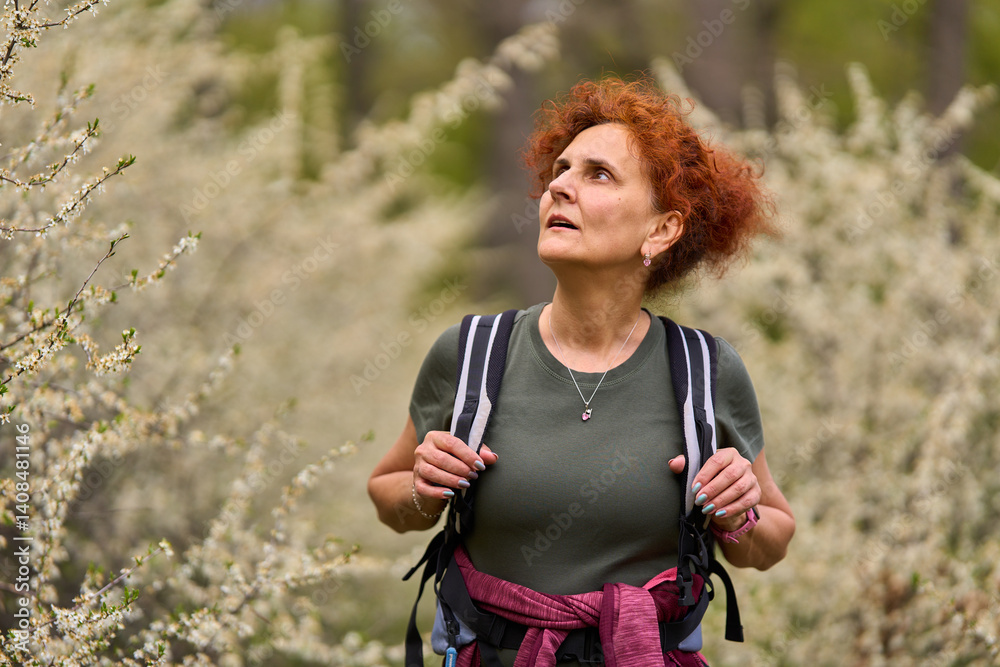 Woman walking through blooming blackthorn