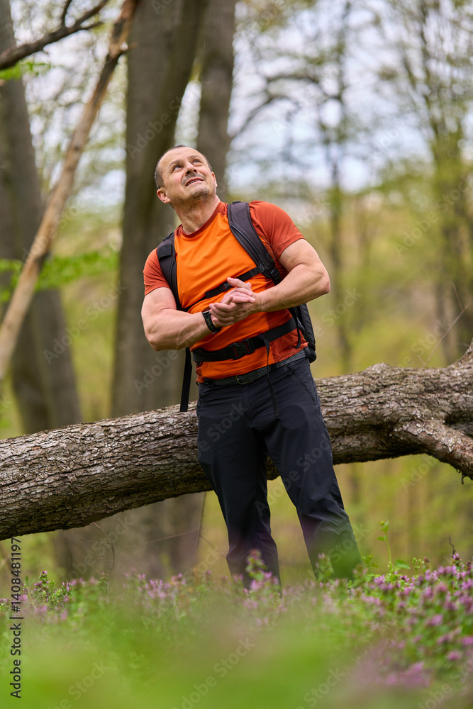 Man looking up in forest trail
