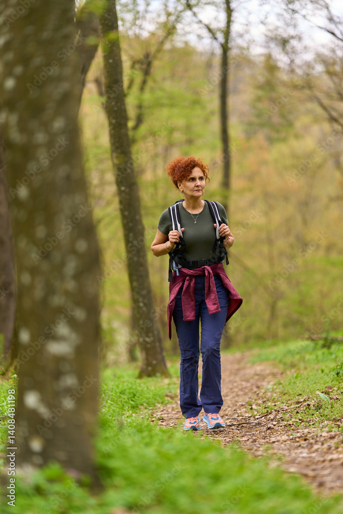 Woman hiking in spring forest