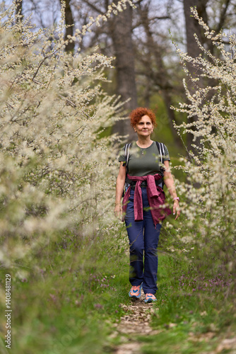 Obraz na płótnie Woman walking through blooming blackthorn w salonie