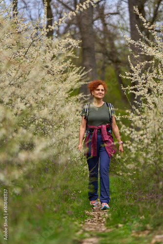 Obraz na płótnie Woman walking through blooming blackthorn w salonie