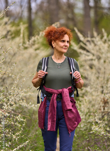 Woman walking through blooming blackthorn