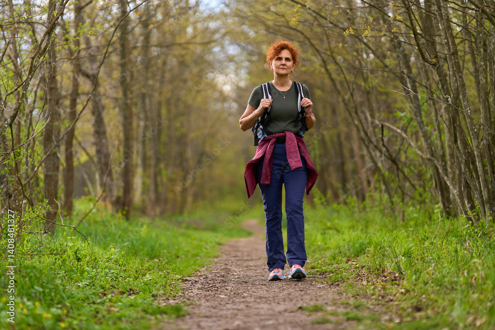 Woman hiking in spring forest