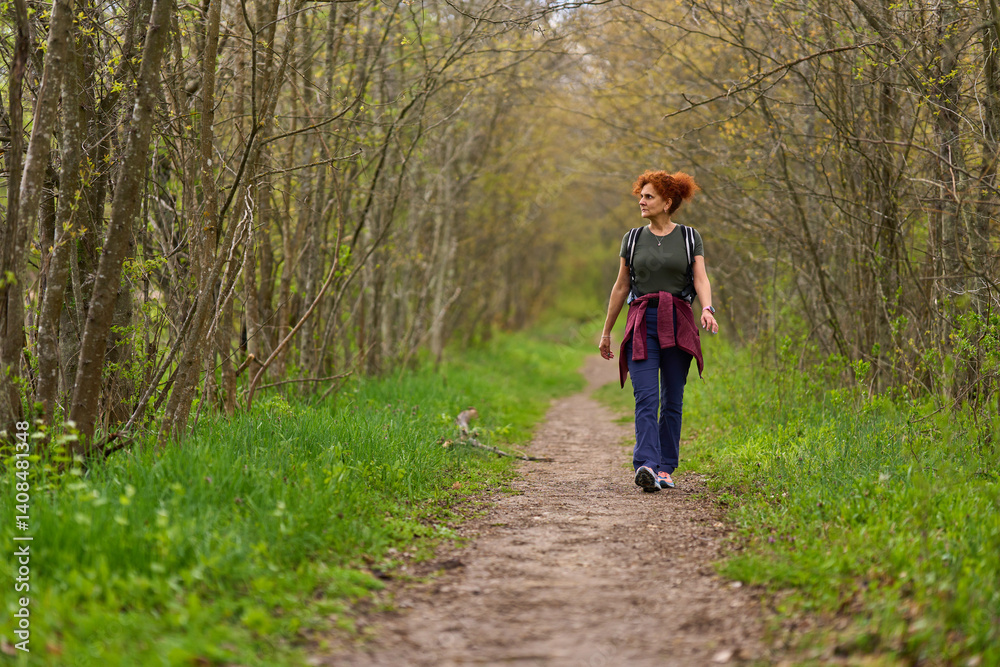 Woman hiking in spring forest