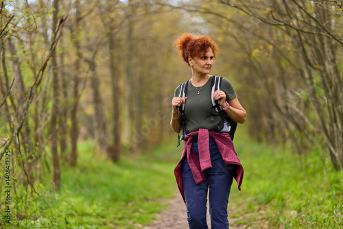 Obraz na płótnie Woman hiking in spring forest w salonie