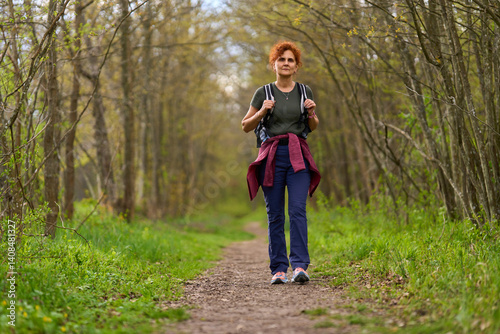 Obraz na płótnie Woman hiking in spring forest w salonie