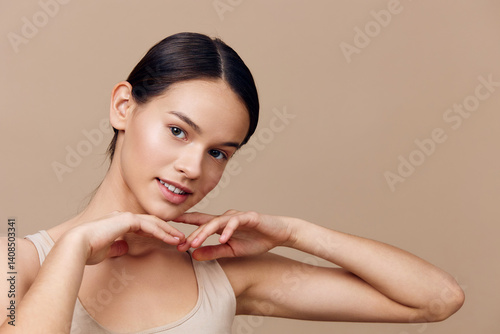 Obraz na płótnie Smiling young model with a neutral background showcasing beauty and confidence, perfect for wellness, skincare, and fashion concepts w salonie