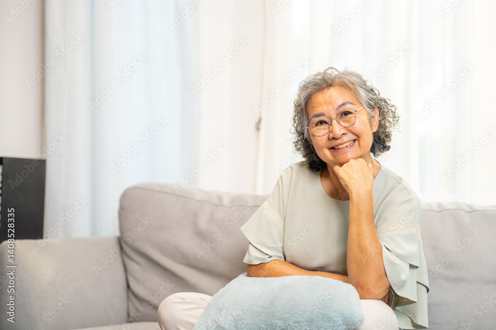 Wellness, mental healthcare in elderly people at home. Portrait of Happy Asian senior mature woman relaxing on sofa in living room. Healthy retired woman enjoy leisure activity hobbies at nursing home Wellness, mental healthcare in elderly people at home. Portrait of Happy Asian senior mature woman relaxing on sofa in living room. Healthy retired woman enjoy leisure activity hobbies at nursing home
