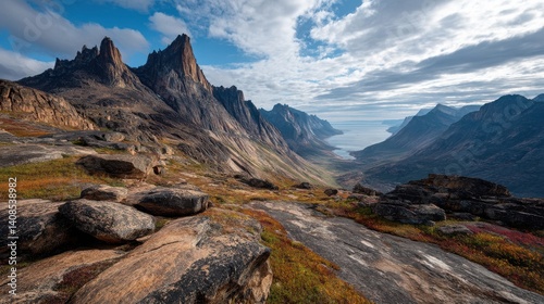 Colorful rock formations and rugged mountains in greenland under cloudy sky