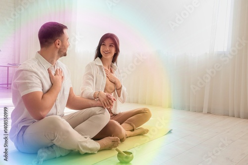 Sporty young couple meditat...