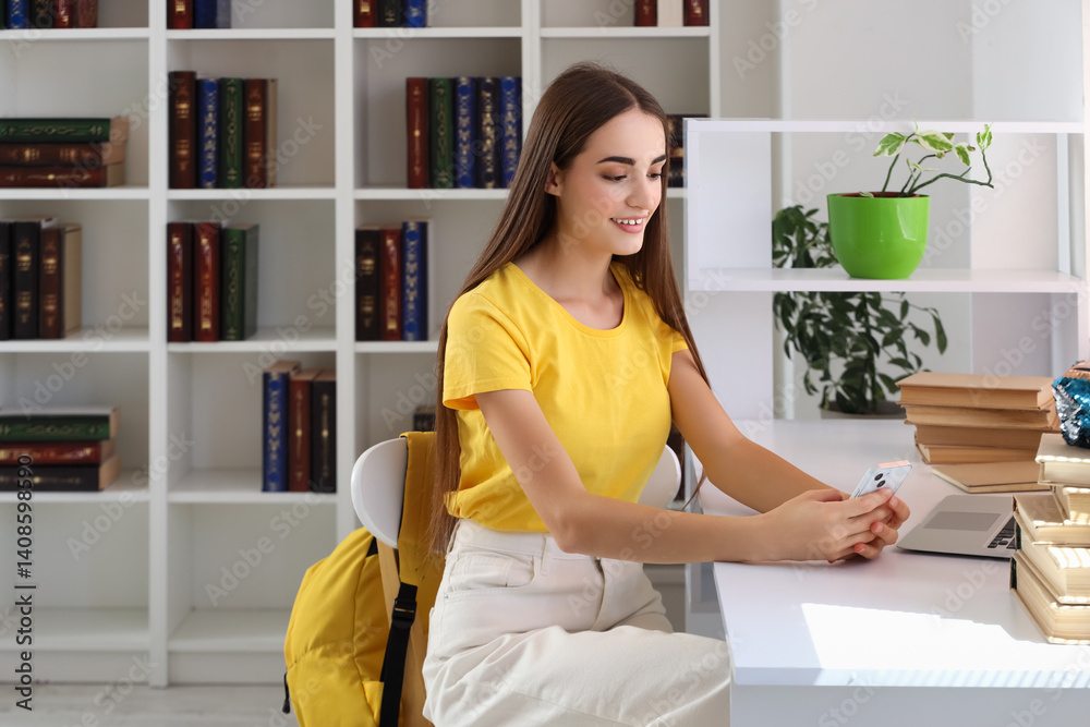 Happy female student with books and mobile phone studying in library Happy female student with books and mobile phone studying in library