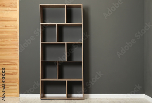 Obraz na płótnie Empty shelving unit and folding screen near grey wall indoors, space for text w salonie