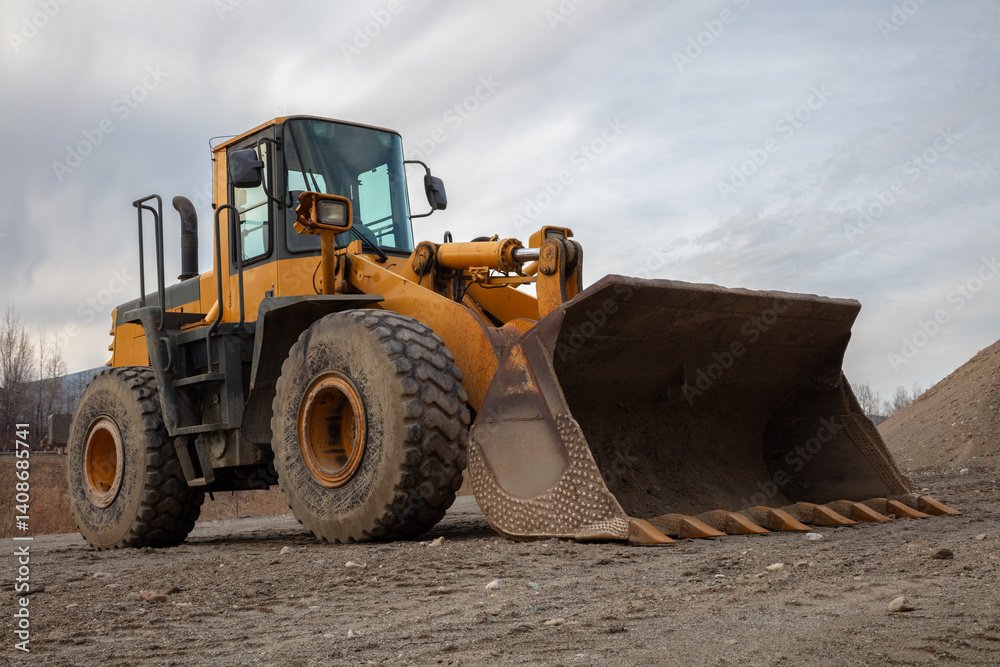Fototapeta premium Yellow Backhoe on Construction Site