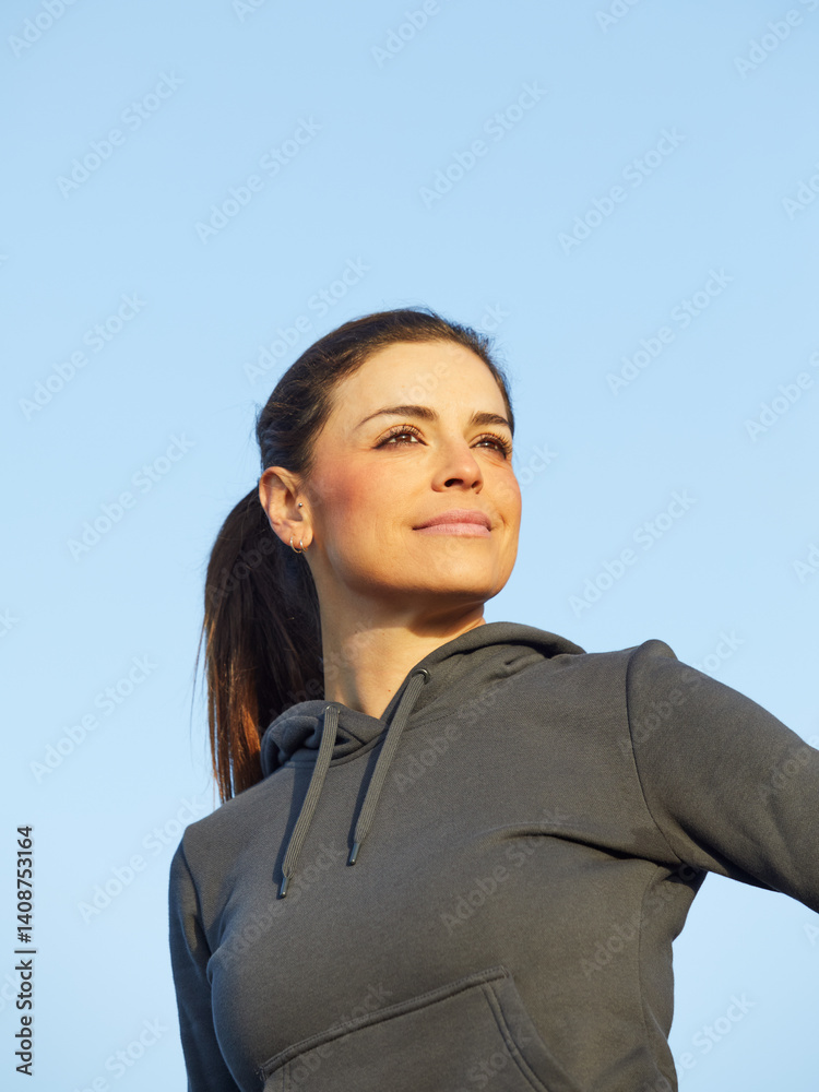 Woman wearing fitness clothes posing, looking away. Woman wearing fitness clothes posing, looking away.