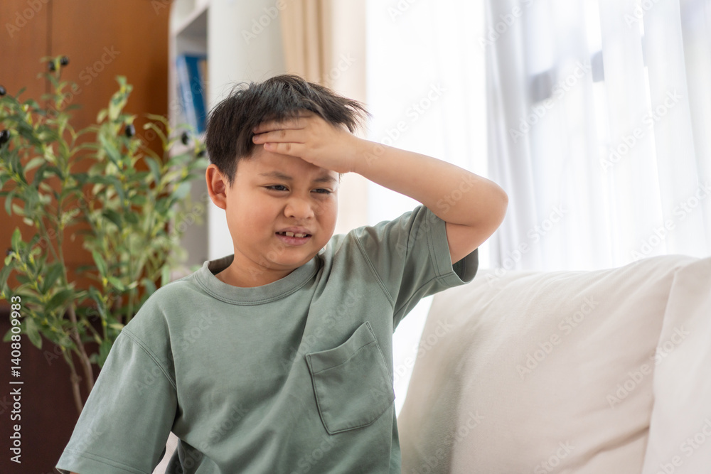 Portrait of sick depressed unhappy child boy touching on head feel suffering head ache pain flu high fever, alzheimer, cancer, stroke disease, cerebral haemorrage, encephalitis, dementia Portrait of sick depressed unhappy child boy touching on head feel suffering head ache pain flu high fever, alzheimer, cancer, stroke disease, cerebral haemorrage, encephalitis, dementia