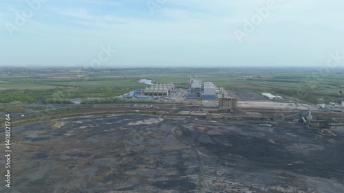 Aerial shot of cooling tower of combine cycle powerplant, Top down electric substation,electrical and production aerial of a working coal burning power plant England  photo