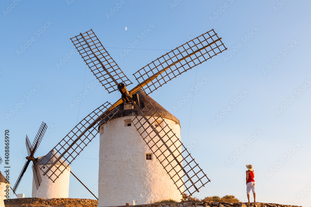 Tourist near windmills on the Don Quixote route, Spain Tourist near windmills on the Don Quixote route, Spain