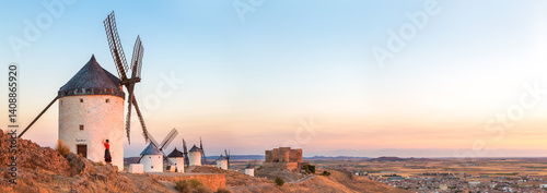 Woman near windmills on the Don Quixote route, Spain