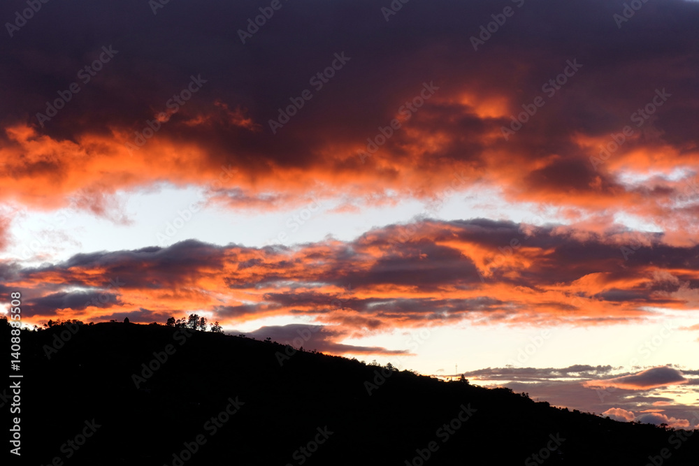 Fototapeta premium Sunset background. Dramatic majestic sunset landscape. Sky with clouds in the background of the light of the dawn sky. Sunset with clouds in various shapes. costa rica
